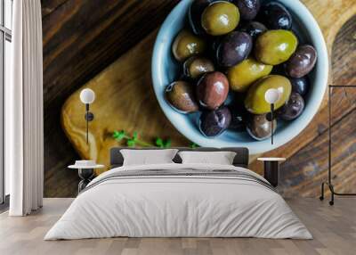 Olives on rustic wooden background Wall mural