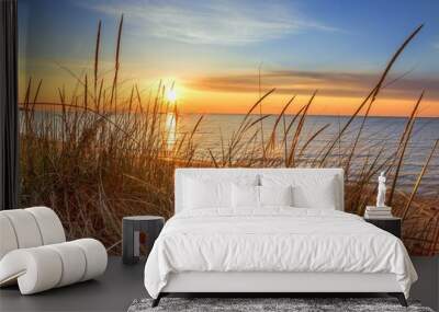 Dawn Of A New Day.Beautiful sunrise illuminates  sand dunes and the blue water horizon as a new day begins. Port Austin, Michigan. Wall mural