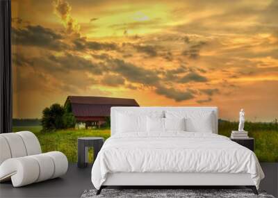 Wooden Barn Sunset. Rural sunset with an abandoned barn surrounded by farm fields. Wall mural