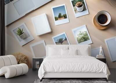 A flat lay photo showcasing various blank photo frames on a wooden surface. with a laptop and small plants adding a touch of warmth. Wall mural