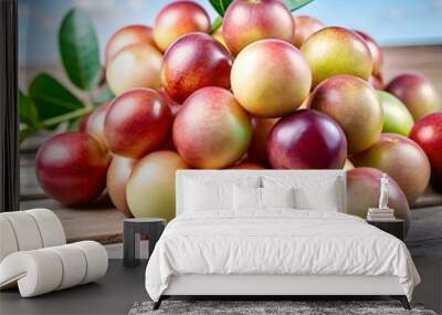 A pile of ripe. colorful fruits on a rustic wooden surface. Wall mural