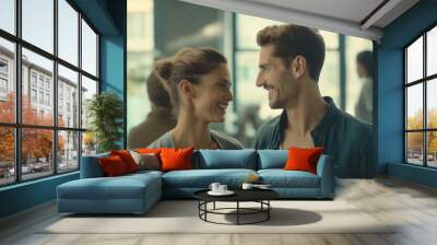 Modern office couple discreetly exchanging smiles during break, capturing subtle workplace romance and connection amidst blurred coworkers. Wall mural