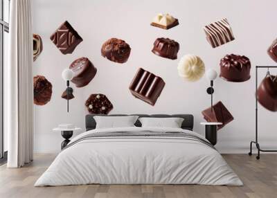 Assortment of chocolate candies and sweets flying in the air on white background. Truffles, creamy milk bonbons, sweet food concept banner Wall mural