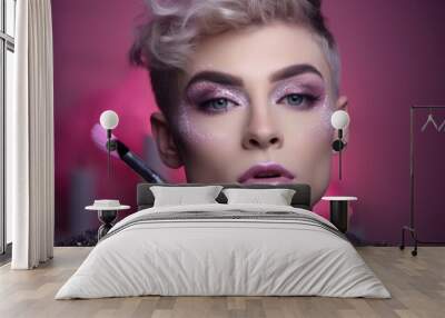 Portrait of young gender fluid non binary person applying make up. Beauty and cosmetics background Wall mural