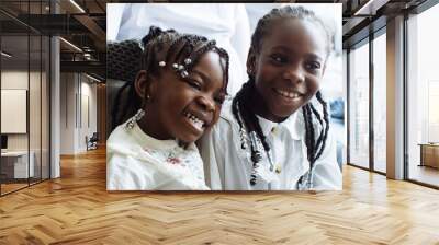 Two sisters laughing together at television show  Wall mural