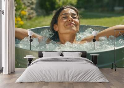 A woman is in a tub of ice water enjoying the cold. Concept of relaxation and rejuvenation. Wall mural