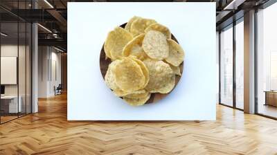 Opak or Cassava chips in wooden plate isolated on white background. Indonesian traditional foods Wall mural