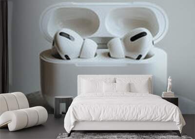 An appealing image of white earbuds on a white display platform Wall mural