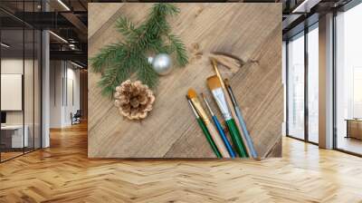 Artistic brushes on a Christmas wooden background. Space for creativity. Banner with copy space for a hardware store or art store. Wall mural