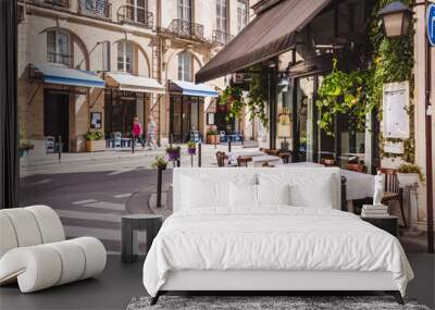 Cozy street with tables of cafe  in Paris, France Wall mural