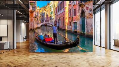 Narrow canal with gondola and bridge in Venice, Italy. Architecture and landmark of Venice. Cozy cityscape of Venice. Wall mural