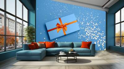 Christmas classic blue color gift box on blue background flat lay Wall mural