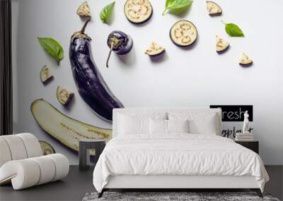 Creative layout from a solid and sliced eggplant on a white background with space for text. Vegetables isolated on white background. View from above Wall mural