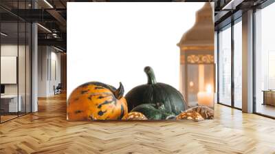 Orange and green pumpkins and a lantern with a burning candle on a white background. Place for text. Autumn background. Wall mural