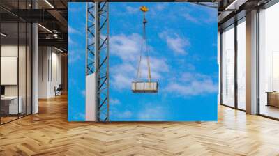 Construction tower crane against the blue sky. Wall mural