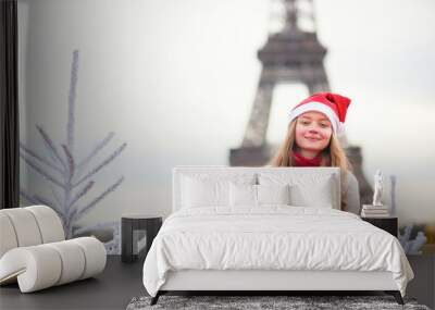 Girl in Santa hat near the Eiffel tower Wall mural