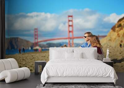 Romantic loving couple having a date on Baker beach in San Francisco Wall mural