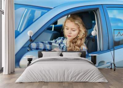 woman using her smartphone while driving a car Wall mural