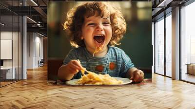 portrait of dirty baby boy with curly hair making funny faces and eating cheese sandwich, carefree sweet peaceful life Wall mural