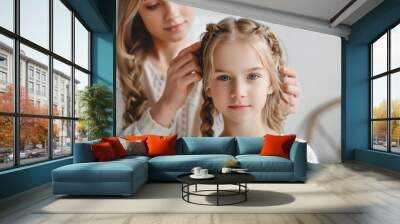 mother braiding hair her daughter  in bathroom and  looking to mirror Wall mural