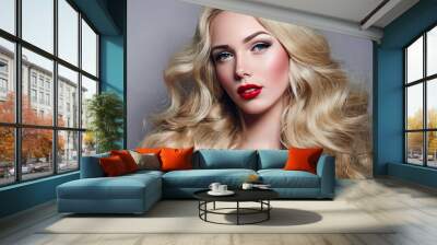 Beautiful young girl with luxurious light wavy hair close-up in the studio. Blonde - shiny, light long hair, curls. Makeup - arrows, red lipstick, pink blush. Cosmetics, hair care. Wall mural