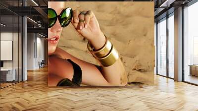 beautiful young tanned healthy girl in bikini lies on the beach. bright sun, summer, heat, rest. acc Wall mural