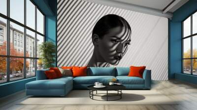 Black and white portrait of a beautiful young girl with a shadow pattern on the face and body in the form of stripes. Wall mural