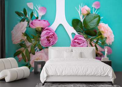 Medical concept of pink lilac flowers shaped in human lungs on blue background. Inflammation of the lungs concept, viral epidemic. Wall mural