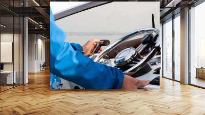 Man's hand on the steering wheel of a motor boat close up Wall mural