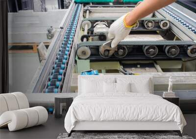 worker maintenance and repair conveyor belt in factory Wall mural