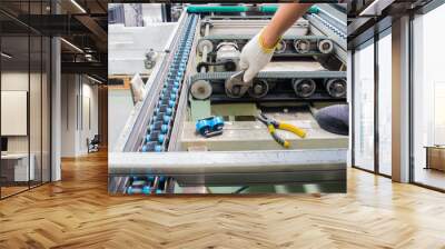 worker maintenance and repair conveyor belt in factory Wall mural