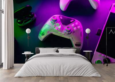 gamer work space concept, top view a gaming gear, mouse, keyboard, game controller, headset, in ear headphone and mouse pad with rgb color on black table background. Wall mural