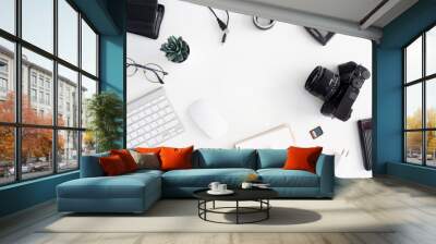 top view of photographer work station, work space concept with digital camera, memory card, keyboard and smartphone on white table background Wall mural