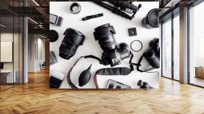 top view of work space photographer with digital camera, flash, cleaning kit, memory card, tripod and camera accessory on white table background Wall mural