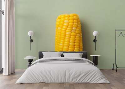 The cob boiled corn on a stick on green background Wall mural