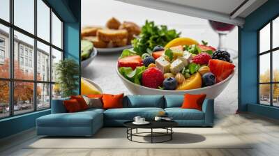 healthy foods arranged in an appetizing way, such as a bowl of colourful salad or fresh fruit on an elegant table Wall mural