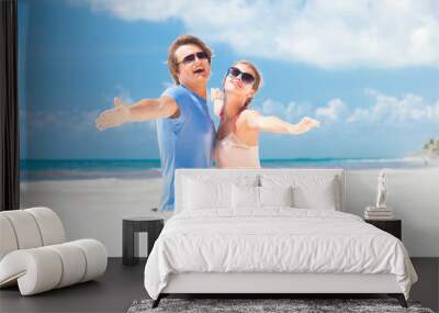 couple in bright clothes on tropical beach smiling in Thailand Wall mural