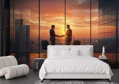 Two businessmen shaking hands in a boardroom overlooking city at sunset Wall mural