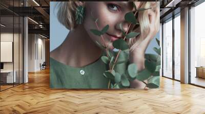 Fashion portrait of blonde female model on grey background. stylish green clothes and accessories. concept of garmonical style and atmosphere Wall mural