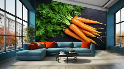 Fresh carrot bunch on dark stone table or black background top view, copy space Wall mural