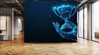 Futuristic concept of achievement in business or sports illustrated with a hand holding a trophy cup on a dark blue background The design features a glowing low polygonal style with Wall mural