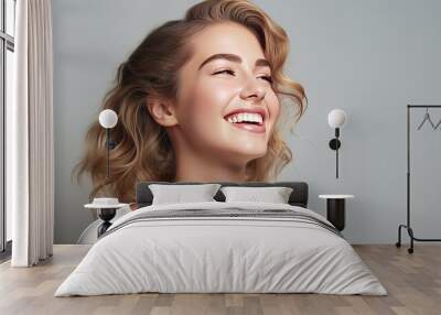 Happy beautiful girl holding her cheeks with a laugh   looking to the side. Pretty woman   clean fresh skin . Expressive facial expressions  .Cosmetology , beauty and Spa Wall mural