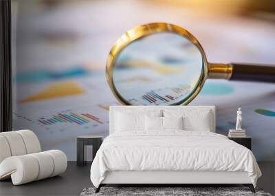 Magnifying glass on graph paper Illustrating financial development or data research focusing on analytics statistics or investment Wall mural