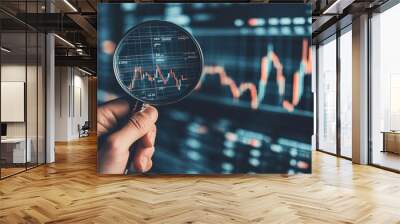 Stock investment concept A businessman holding a magnifying glass over a virtual stock chart representing financial analysis market growth and economic forecasting Wall mural