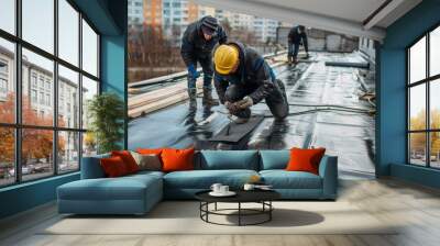 Workers professionally insulate the rooftop with a bitumen membrane, detailing waterproofing at the construction site. Wall mural