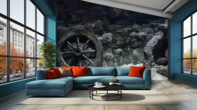 Fish tank decoration. Decorative cartwheel and wooden snag under Wall mural