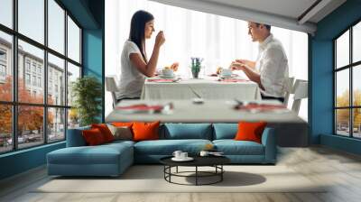 Two casual young adults having a conversation over a meal.Formal proposal,talking in a restaurant.Trying food,offers,special menu.Happy couple eating course in hotel.Meeting,date,special occasion Wall mural