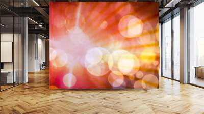 Abstract light circular bokeh background in red and yellow colors and light rays. Wall mural