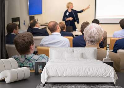 Business woman is speaking on conference. Wall mural