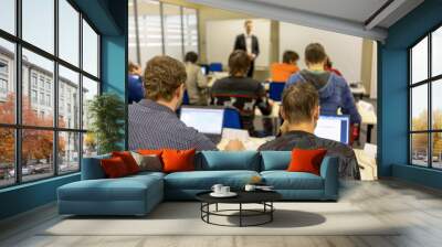 people sitting rear at the computer class Wall mural